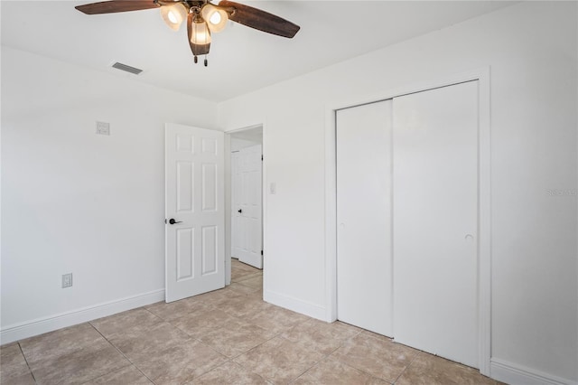 unfurnished bedroom featuring ceiling fan, a closet, and light tile patterned floors