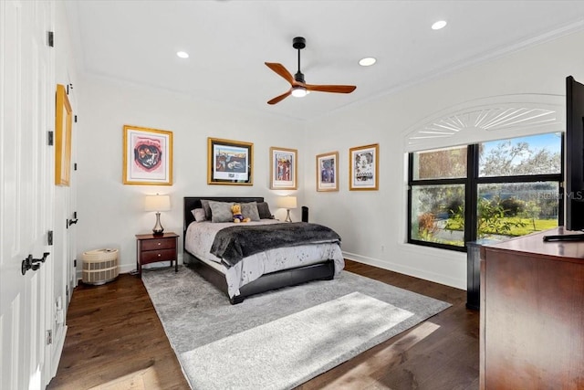 bedroom featuring dark hardwood / wood-style floors, ceiling fan, and crown molding