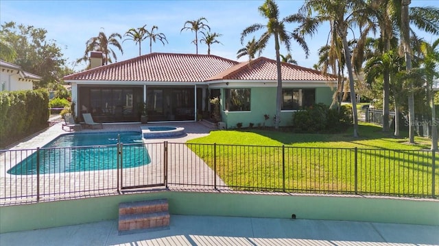 view of swimming pool featuring a lawn, a sunroom, and an in ground hot tub