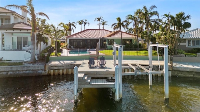 view of dock featuring a yard, a patio, and a water view