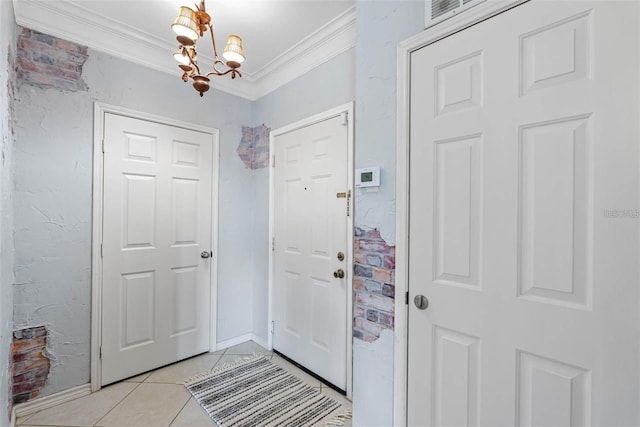 entrance foyer featuring crown molding, light tile patterned floors, and an inviting chandelier