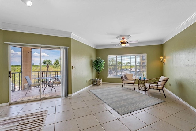 living area featuring a wealth of natural light, crown molding, ceiling fan, and light tile patterned flooring