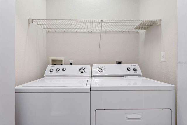 washroom with washing machine and clothes dryer