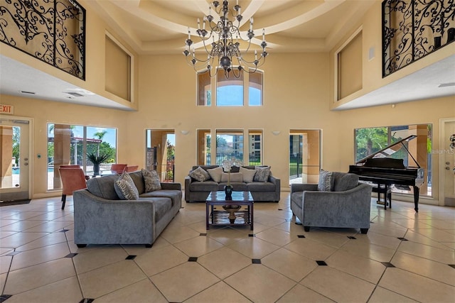 tiled living room with a wealth of natural light, a high ceiling, and an inviting chandelier