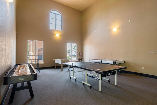 playroom featuring a towering ceiling and carpet floors