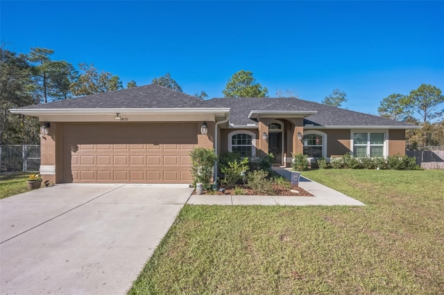 ranch-style house with a garage and a front lawn