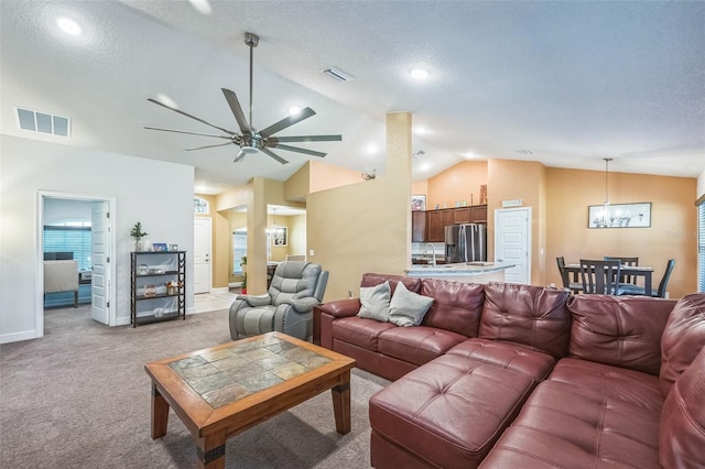 carpeted living room featuring a textured ceiling, ceiling fan, sink, and lofted ceiling