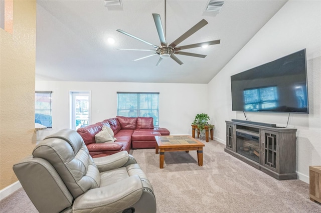 living room with ceiling fan, light carpet, and vaulted ceiling