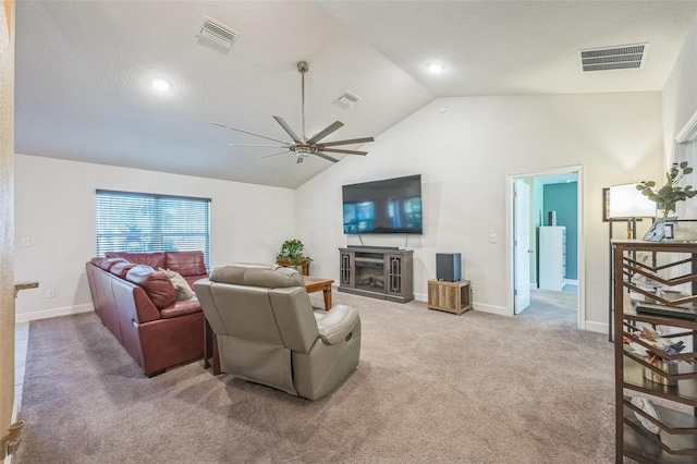 carpeted living room with ceiling fan, a textured ceiling, and vaulted ceiling