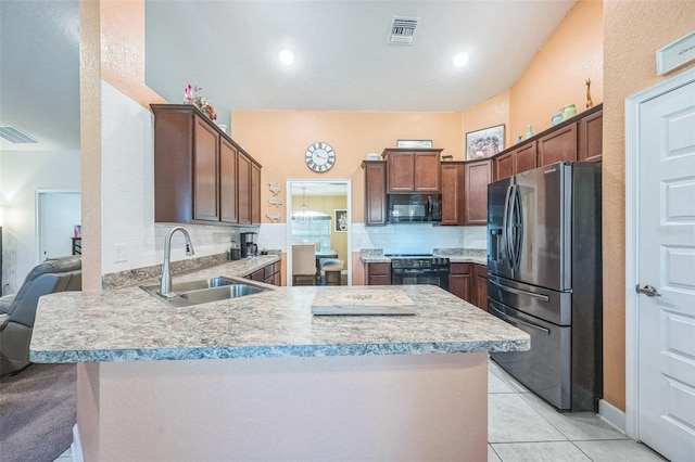 kitchen featuring sink, backsplash, kitchen peninsula, light tile patterned flooring, and black appliances