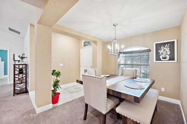 carpeted dining space featuring lofted ceiling, a chandelier, and a textured ceiling