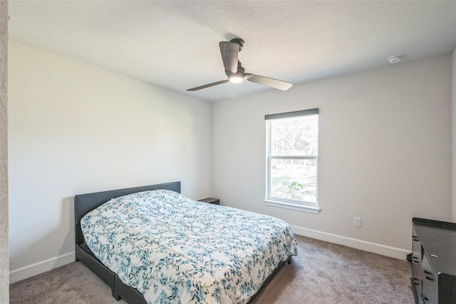 carpeted bedroom with a textured ceiling and ceiling fan