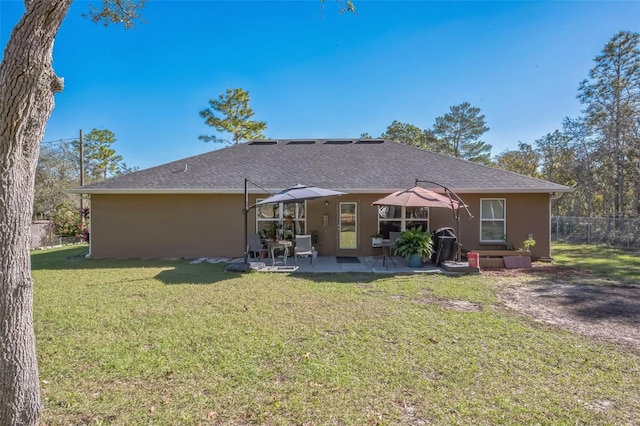 rear view of house with a patio area and a yard