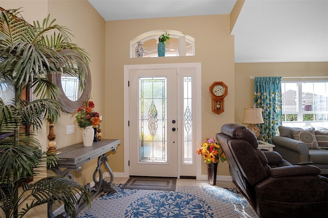 entrance foyer featuring a wealth of natural light and light tile patterned flooring