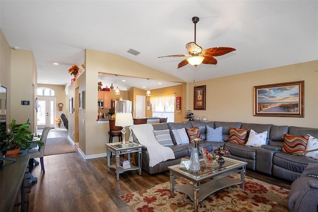 living room featuring ceiling fan, dark wood-type flooring, and lofted ceiling