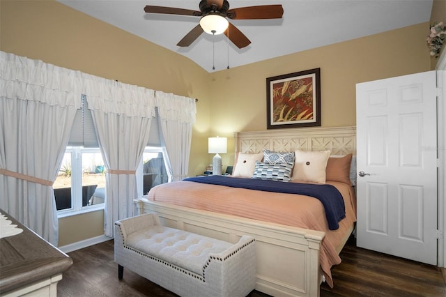 bedroom featuring dark hardwood / wood-style flooring, vaulted ceiling, and ceiling fan