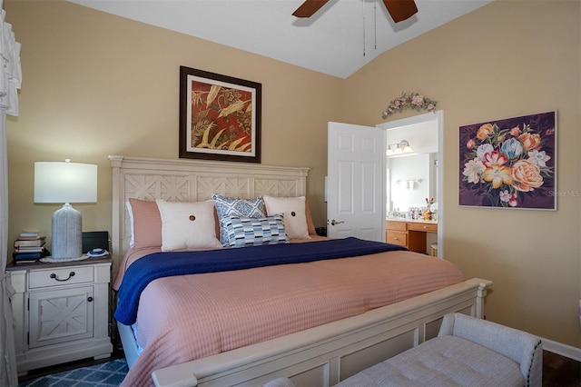 bedroom featuring ceiling fan, ensuite bathroom, vaulted ceiling, and hardwood / wood-style flooring