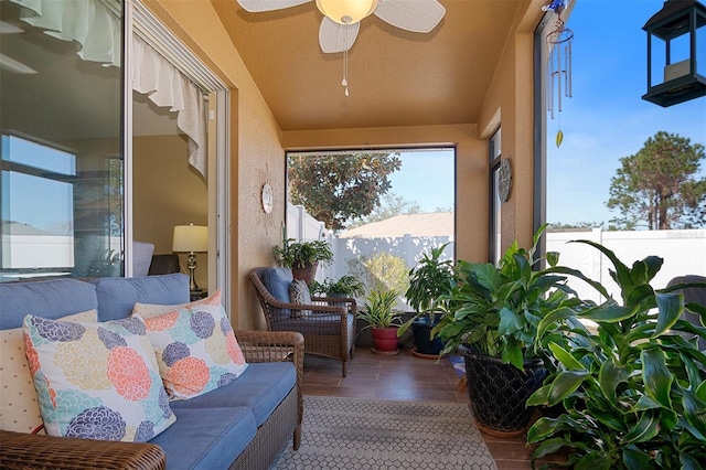 sunroom / solarium featuring ceiling fan