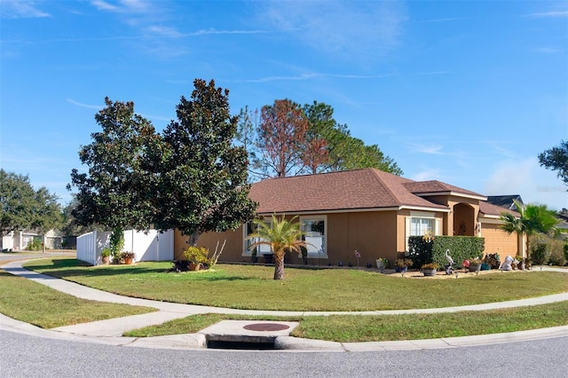 ranch-style home featuring a front yard and a garage