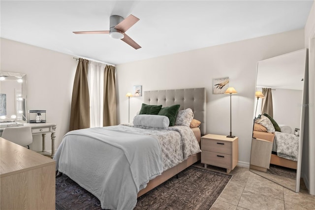 tiled bedroom featuring ceiling fan