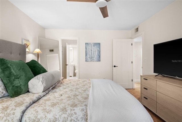 bedroom with wood-type flooring, ensuite bath, and ceiling fan