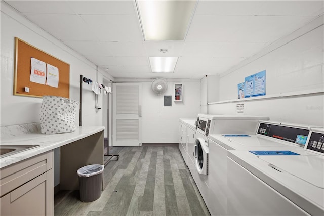 clothes washing area with dark hardwood / wood-style flooring and washing machine and clothes dryer