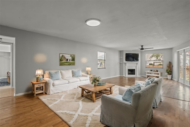 living room featuring ceiling fan and light hardwood / wood-style floors