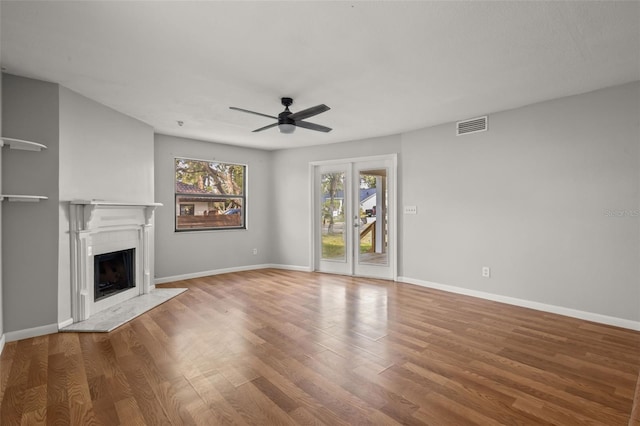 unfurnished living room featuring hardwood / wood-style flooring and ceiling fan