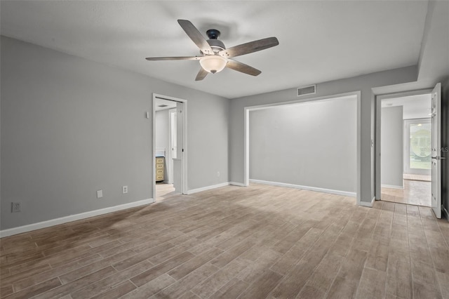 spare room with hardwood / wood-style floors and ceiling fan