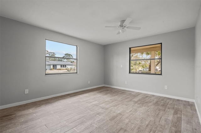 empty room with light hardwood / wood-style flooring and ceiling fan