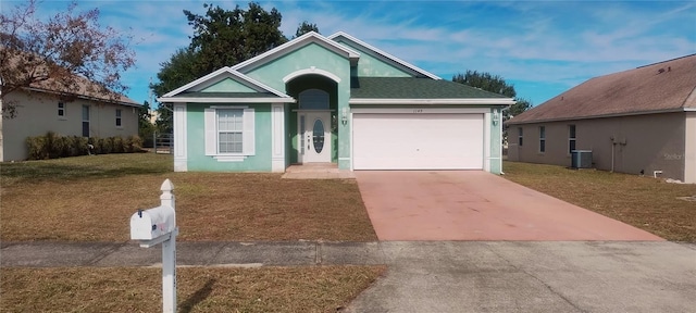 ranch-style home with cooling unit, a garage, and a front lawn