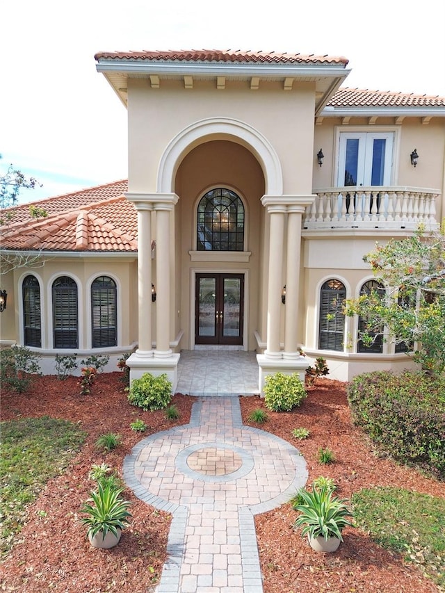 property entrance with french doors and a balcony