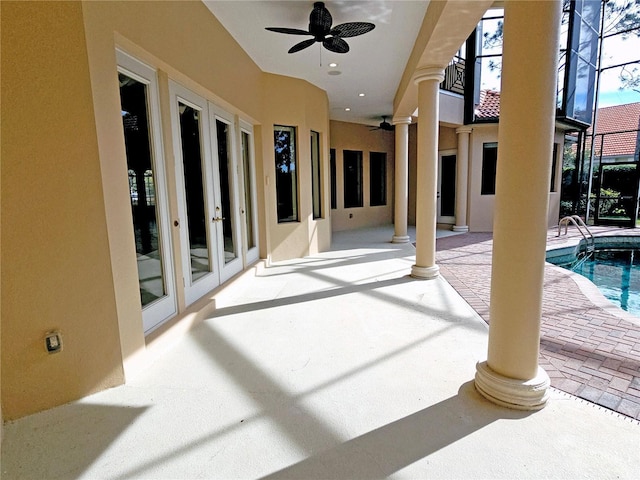 view of patio featuring ceiling fan, a lanai, and french doors