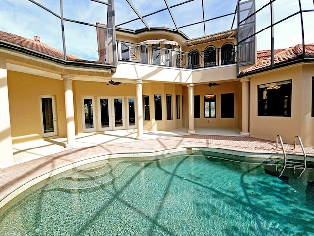 view of swimming pool with a lanai, a patio area, ceiling fan, and french doors