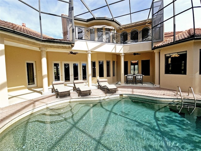 view of swimming pool featuring french doors, a lanai, ceiling fan, and a patio area