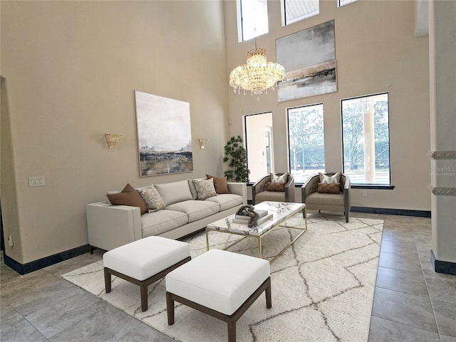 living room with a high ceiling, an inviting chandelier, and tile patterned floors