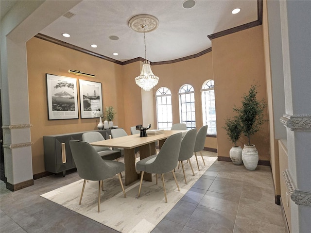 dining space with crown molding, tile patterned flooring, and a notable chandelier