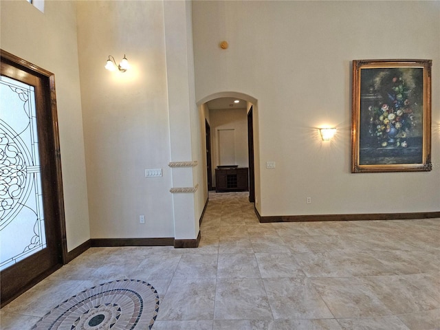 entryway with a towering ceiling