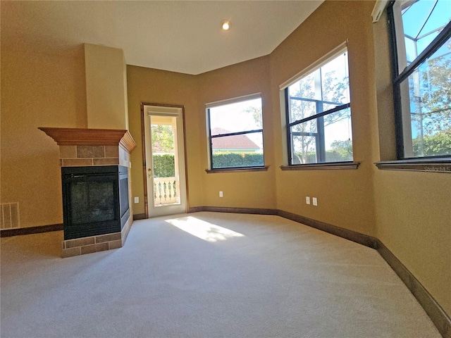 unfurnished living room featuring carpet floors and a fireplace