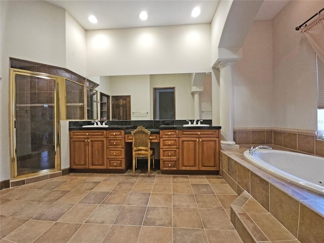 bathroom featuring plus walk in shower, tile patterned floors, decorative columns, a towering ceiling, and vanity