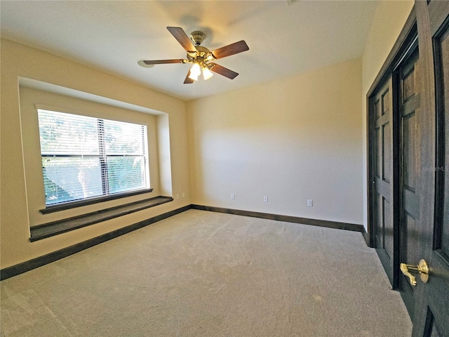 carpeted empty room with ceiling fan