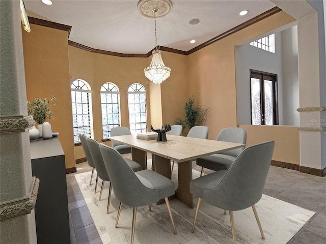 dining space with ornamental molding, a wealth of natural light, and an inviting chandelier