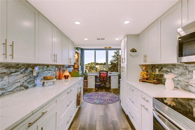 kitchen featuring tasteful backsplash, dark hardwood / wood-style flooring, and white cabinets