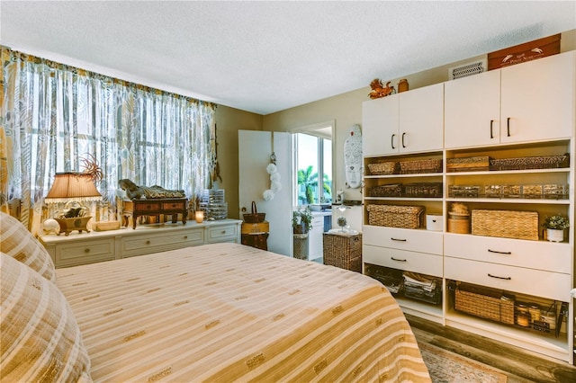 bedroom featuring wood-type flooring and a textured ceiling