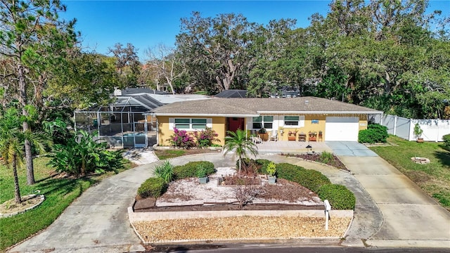 ranch-style home featuring a lanai and a front lawn