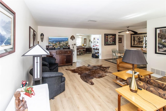 living room with ceiling fan and light wood-type flooring