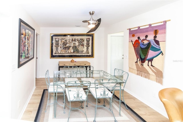 dining room featuring wood-type flooring and ceiling fan