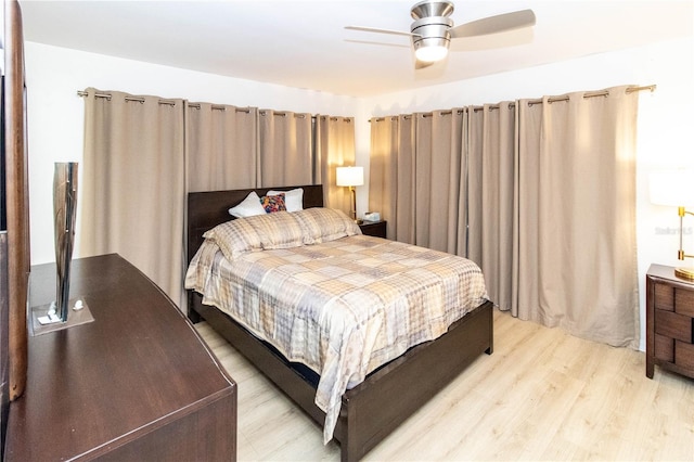 bedroom with light wood-type flooring and ceiling fan