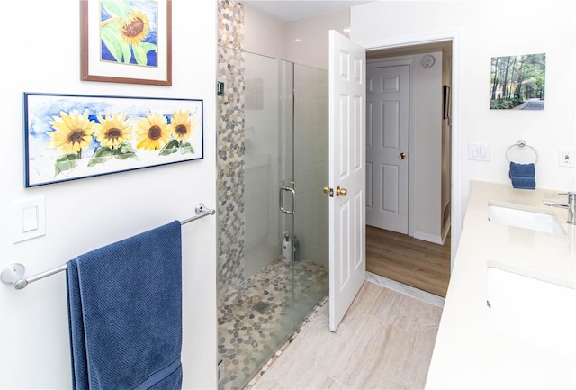 bathroom featuring vanity, a shower with shower door, and hardwood / wood-style floors