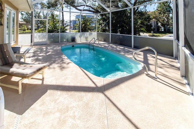 view of swimming pool with a patio and glass enclosure